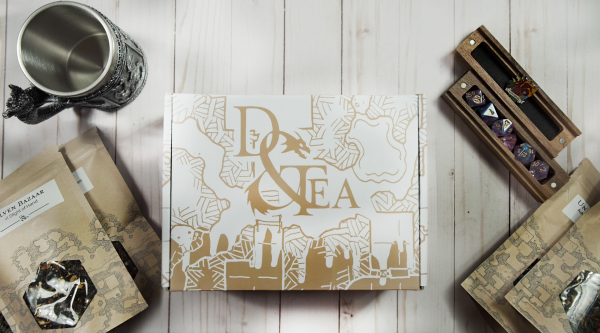 subscription box with tea and dice around it