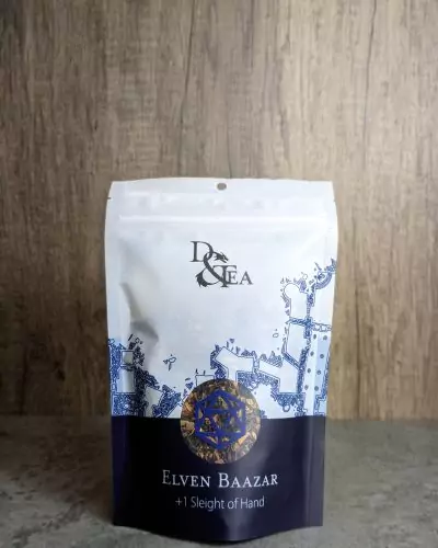Tea inspired by DnD in front of packaging for Elven Bazaar tea in packaging with dungeon map from Dyson Logos